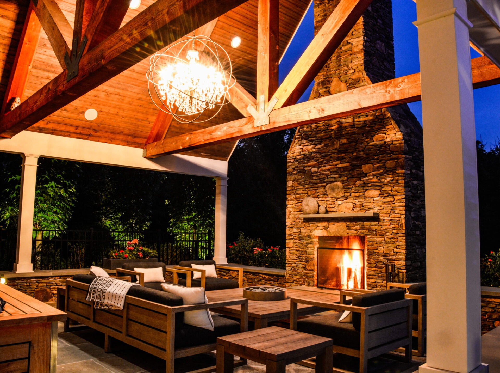Outdoor Living Spaces including a beautiful seating area around an outdoor fireplace.